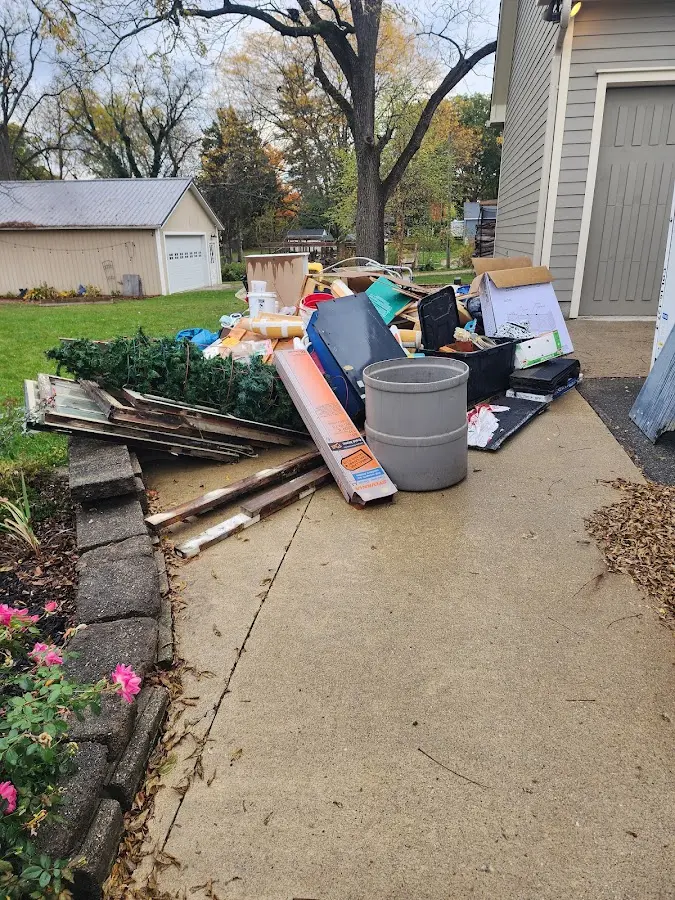 Dumpster being loaded with debris for Estate Cleanout Dumpster Rental in Sebring